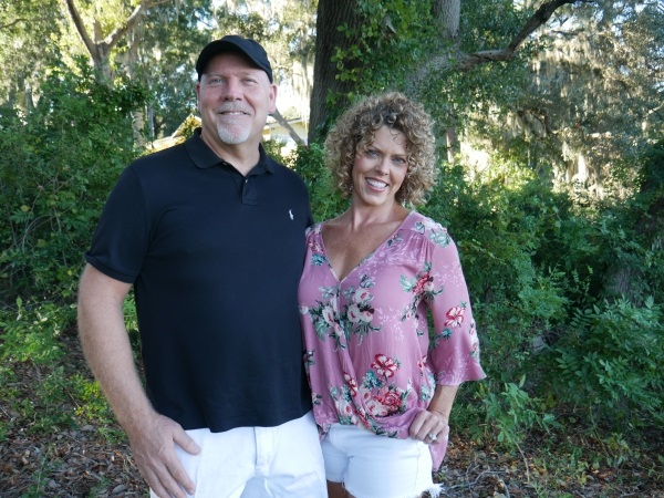 GG and her husband standing together in the yard